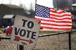 In one of the contests ahead of Super Tuesday on March 5, a vote sign and American flag are shown outside a Michigan primary election location in Dearborn, Mich., on Feb. 27.