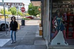 A woman walks past Things From Another World, a Dark Horse Comics shop, in Milwaukie, Ore., in May. The store closed in June.