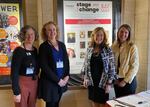 Left to right: Sharon Maier-Kennelly, Stephanie Turner, Ruthie Pincus, and Dani Wyeth pose in front of a Stage the Change 2022 sign at the Tower Theatre in Bend, Ore.