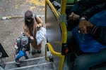 A mother and her child from the city of Pokrovsk, Ukraine, board a bus joining other evacuees in Pavlohrad, on Oct. 19. They were transferred to a train headed for western Ukraine or farther into Europe. Pokrovsk, a coal mining center in eastern Ukraine, is under frequent artillery barrages and aerial attacks by the Russians who are making a push into the region.