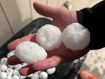 In this image provided by Jeremy Crabtree, large chunks of hail are shown Wednesday night, in Shawnee, Kan. Volatile weather honed in on parts of Kansas and Missouri, with some storms dumping massive chunks of hail.