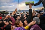Earthquake survivors gather at a diaper distribution in Hatay, Turkey, on Feb. 7, a day after a 7.8-magnitude earthquake struck the country's southeast.