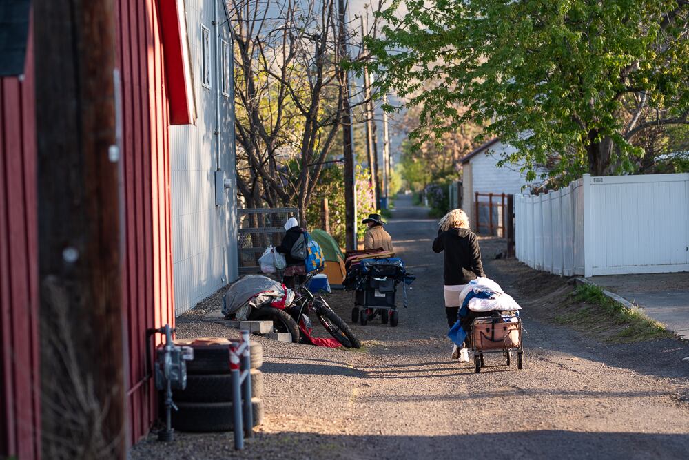 Since camping and shelter restrictions were passed, Clarkston’s homeless encampment has dwindled from 75 people to about 20. Those who remain are forced to move their belongings, creating piles of supplies in an alleyway near Foster Park.