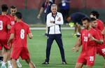 Iran's coach, Carlos Queiroz, heads a training session at in Doha on Monday. Iran can tie  the U.S. and still advance, but is expected to hold nothing back in pursuit of a win.