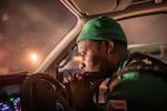 Paramedic Papinki Lebelo waits for a police escort before responding to an emergency call-out in the Red Zone neighborhood of Philippi East in Cape Town, South Africa. Due to a rise in attacks on paramedics, large parts of the city are only accessible to ambulance crews when they have a police escort. This severely delays response times.