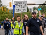 International Aerospace Machinists union members march toward the union's hall Thursday to vote on a contract offer with airplane maker Boeing in Renton, Wash.