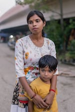 NEW DELHI, INDIA - OCTOBER 13, 2026: Kanchan and her son pose at home in the Muslim-majority neighborhood Bela Slum in New Delhi, India, October 13, 2026. Kanchan was deleted in the Special Intensive Revision (SIR) draft roll due to permanent relocation after his house was demolished.