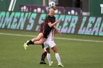 Portland Thorn's Lindsey Horan (10) jumps over OL Reign's Angelina (26) for a header during an NWSL Challenge Cup soccer match, in this file photo on Wednesday, April 21, 2021, in Portland, Ore. Thorns midfielder Lindsey Horan has been loaned to French club Lyon through the summer of 2023.