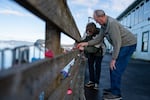 David and Cindy Parker lock a heart-shaped padlock, on which they wrote “53 years”, to Pier 39 in celebration of their love in Astoria, Ore., on Feb. 12, 2026.