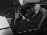 John DeLorean sitting in his DeLorean sports car at the Earl's Court motor Fair in October 1981.