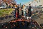 Immigrants from Portland, including Victor Cruz, center right, in the gray hooded sweatshirt, embrace family members after being released on bond in Tacoma, Wash., Friday, Nov. 7, 2025.