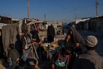 People stroll through the marketplace in the al-Hol detention camp on Jan. 30, 2025 in northeastern Syria's Hassakeh province, where tens of thousands of mostly women and children linked to the Islamic State group have been living for years.