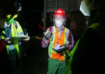 Douglas Young, center, gives instructions to his teammates while serving as team lead during a Neighborhood Emergency Teams training scenario. The volunteer teams were instructed to quickly assess potential hazards and classify people they discovered based on injury level.