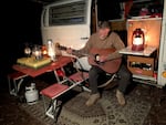 Bob Koscik has his own way of connecting to a bygone era of camping, including his 1969 VW bus, acoustic guitar and collection of railroad lanterns.