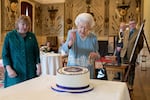 Feb. 5, 2022: Queen Elizabeth II cuts a cake to celebrate the start of the Platinum Jubilee during a reception in the Ballroom of Sandringham House  in King's Lynn, England.