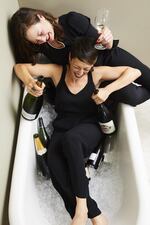 Dana Frank and Andrea Slonecker pair Champagne with laughs in a bathtub.