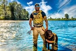 Chad Brown with his dog Axe on the Willamette River, Oregon.