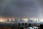 Thick heavy smoke from wildfires shrouds downtown Los Angeles on Wednesday, Jan. 8, 2025.