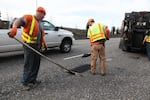An ODOT maintenance crew fills potholes on Highway 26.