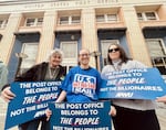 Three U.S. postal workers participate in a rally at Eugene's main Post Office. Pictured from left to right, Roslyn Murray, Cassidy DiIenno and Jamie Donaghue.