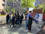 Protesters use e-bikes to block the vehicle exits from the Henry M. Jackson Federal Building on June 10, 2025, hoping to stop trucks carrying detained immigrants from leaving.