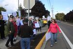 Protesters line the sidewalk near McMinnville High School, where U.S. Education Secretary Betsy DeVos visited Wednesday, Oct. 11, 2017.