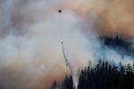 In this Sept. 3, 2020, photo provided by the Opal Creek Ancient Forest Center, fire retardant is dropped at Jawbone Flats in the Opal Creek Wilderness in Oregon.