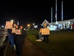 Protestors gather with signs outside of Newport City Hall on Nov. 12, 2025.