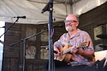 Steve Cheseborough performs an intimate show in the shaded Crossroads Stage. He is a one-man show who stays true to his Delta blues roots in every song.