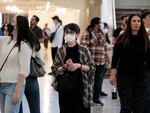 A woman wears a mask indoors in Manhattan earlier this year, in New York City. The city's public health commissioner issued new guidance on Friday advising New Yorkers to wear face coverings in all public spaces.