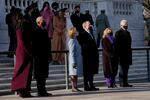 From left to right, Michelle and Barak Obama, Laura and George W. Bush, Hillary and Bill Clinton stand on the steps of the tomb while facing forward. They're all dressed in winter clothes and wearing face masks.