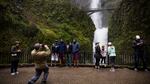 Tourists take pictures next to Multnomah Falls, April 13, 2018.