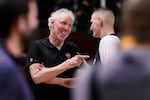 FILE - Basketball Hall of Fame legend Bill Walton, left, jokes with Denver Nuggets center Nikola Jokic during a practice session for the NBA All-Star basketball game in Cleveland, Feb. 19, 2022.
