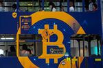 An advertisement for the cryptocurrency Bitcoin is displayed on a tram in Hong Kong. Cryptocurrencies have surged to nearly $2.5 trillion in total value, rivaling the size of G7 economies like Canada’s and Italy’s, with more than 200 million users. In the latest milestone for the industry, an easy-to-trade fund tied to Bitcoin began trading on Tuesday, Oct. 19, 2021. (AP Photo/Kin Cheung, File)