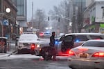 FILE - A law enforcement official directs traffic in a neighborhood near Brown University, Sunday, Dec. 14, 2025, in Providence, R.I., following a Saturday, Dec. 13, shooting at the university. (AP Photo/Steven Senne)