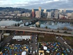 In this aerial photo taken with a drone, homeless camps are seen in a vacant parking lot on the central eastside in Portland, Ore., Tuesday, Dec. 8, 2020.