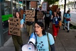 Vasiliki Touhouliotis, an honors college adjunct faculty member and chair of bargaining for the Portland State University Faculty Association, leads chants as union members, students and other supporters march to PSU President Ann Cudd’s office in downtown Portland, Ore., on Thursday, Oct. 16, 2025.