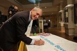 Mayor Charlie Hales signs Beverly Clearly's 100th birthday card at Wordstock.