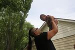 Dyami Ellis plays with infant son Brave Bear seven weeks after their entire household tested positive for COVID-19. Culver, Ore., June 24, 2020.