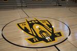 Roosevelt High School's gym floor features a new logo for the high school. The center of the old basketball court is now embedded in a nearby lobby floor — a nod to Roosevelt's history.