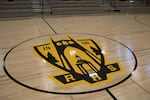 Roosevelt High School's gym floor features a new logo for the high school. The center of the old basketball court is now embedded in a nearby lobby floor — a nod to Roosevelt's history.