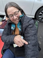 Chris DeMoll of Yachats points to bird droppings on her coat from the Vaux's Swifts flying overhead.