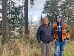 Hanford McCloud, left, and Wille Frank III, stand on a bluff above the Nisqually River delta that pours into the south Puget Sound.