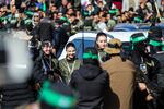 Hamas fighters escort four Israeli hostages to hand them over to a team from the Red Cross in Gaza City on January 25, 2025. Hamas militants handed over four Israeli women hostages to the Red Cross in a January 25 swap after parading them on a stage at a square in Gaza, an AFP journalist reported.