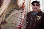 Bill Oldridge of BillyBob's Butchers in Elgin, stands next to a side of beef on Thursday, Jan. 19, 2023. Oldridge said he numbers each side that goes through his plant so people know exactly where their food comes from.