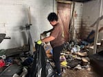 Eva Williams, wife of Fight the Blight founder Matt Williams, works to clean the basement of someone with hoarding disorder. The homeowner decided to clear out their home after attending Fight the Blight's course and support group.