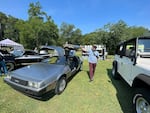 Fernando Alfonso next to his DeLorean DMC-12 at a 2023 Independence Day car show in Brookhaven, Ga.