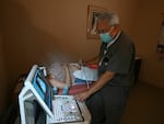 Dr. Franz Theard performs a sonogram on a patient seeking abortion services at the Women's Reproductive Clinic in Santa Teresa, New Mexico, a state that has not banned abortions.