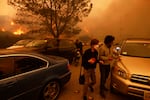 People flee from the advancing Palisades Fire, by car and on foot, in the Pacific Palisades neighborhood of Los Angeles.