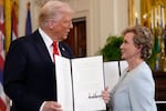FILE - President Donald Trump holds up a signed executive order alongside Secretary of Education Linda McMahon in the East Room of the White House in Washington, Thursday, March 20, 2025.